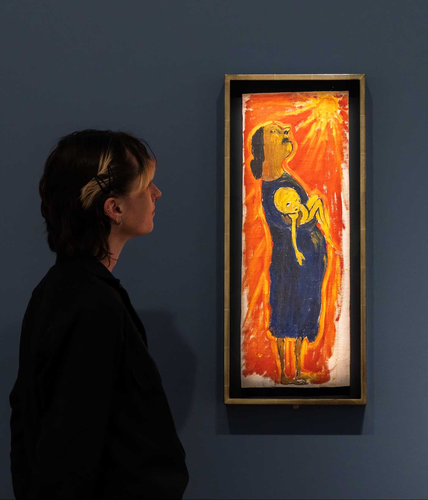 En kvinne ser på verket Tørken, av Paula Rego. Fotografi