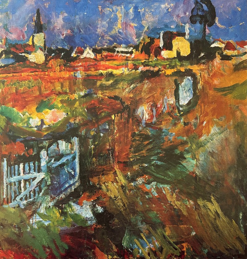 A meadow with a white fence and a white gate. It is autumn, and the meadow is painted in shades of orange, yellow, red, and green. In the background, there are houses, a church spire, and a blue sky.