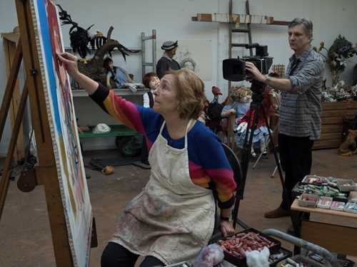 Photo of Paula Rego painting in her studio.